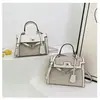 Bolsos estilo nuevo candado bolso Kelly, bolso de mano de moda europeo y americano con bloques de color para mujer, bolso cruzado de hombro texturizado y empalmado