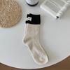 Etiqueta de talón a juego de color calcetines de punto grueso Corea del Sur hilo de punto calcetines de tubo apilados niños hombres y mujeres parejas calcetines Zhuji al por mayor