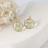 Aretes exquisitos de flor real de venta caliente transfronteriza resina gota pegamento joyería de flor seca aretes nomeolvides joyería artesanal al por mayor