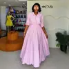 Moda outono 2026 transfronteiriça europeia e americana, novo conjunto elegante de camisa listrada e saia longa para mulheres