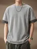 Camiseta de manga curta de alta qualidade, minimalista e versátil para homens, apresentando um novo design de verão com um padrão patchwork xadrez, corte solto, gola redonda e tecido de peso pesado, tornando-a uma peça da moda