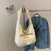Bolsa de Gran Capacidad para Mujer 2025 Nueva Versátil Bolso de Hombro de Lona Bolsa de Tela Popular de Este Año Bolso Tote Cubo para Viajar