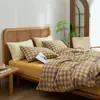 Juego de cuatro piezas de algodón 100% teñido en hilo y lavado, algodón puro, sin marca, suministrado por el fabricante, funda de edredón de alta calidad, sábana bajera de estilo japonés, ropa de cama al por mayor