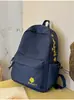 Mochila azul marino de estilo americano con color de contraste, estilo universitario fresco, adecuada para estudiantes, versátil para ir al trabajo y uso casual.
