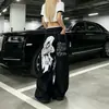 Jeans de calle ligeros estilo americano con estampado de graffiti de alas y costuras visibles, pantalones de algodón unisex de pierna ancha acampanados multibolsillos hasta el suelo