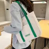 2023 Bolsa Tote Portátil Simples de Lona com Letras de Grande Capacidade Bolsa de Lona Fashionable Bolsa de Ombro Casual Estilo Coreano para Estudantes Universitárias