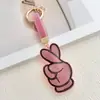 Colgante llavero "Bie" con incrustaciones de diamantes transfronterizo, accesorio creativo de bolsa de mano de terciopelo de cuero con pedrería, llavero de coche