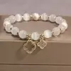 2025 Nova Pulseira de Vidro Olho de Gato Imitado Trevo de Quatro Folhas Cordão Elástico Nicho Pulseira de Pérolas