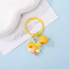 Llavero de oso con cascabel y lazo de resina de macarrón, accesorio DIY, regalo cultural y creativo, colgante con cuentas