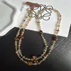 Cadena para teléfono larga cruzada con estampado de leopardo, bola de diamantes, llavero, colgante de cuentas de alta gama, accesorio para cámara