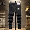 Jeans Preto Puro Primavera 2025 Marca da Moda Masculina Slim Fit Perna Afunilada Verão Estilo Coreano Calças Casuais Jovens Masculinas Atacado