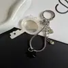 Cadena de teléfono de hueso de serpiente de espejo acrílico simple y fresca, llavero versátil creativo y colgante para bolso
