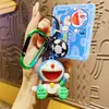 Llavero auténtico de Doraemon con diseño de experto deportivo, colgante creativo de mochila escolar con dibujo de coche, regalo pequeño para pareja, venta al por mayor