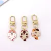 Colgante de gatito lindo de aleación estilo japonés Llavero de coche mini Colgante para AirPods Accesorio para bolso pequeño