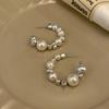 Nuevos aretes grandes semicírculo de perlas de diseño nicho de lujo ligero 2023 nuevos aretes sencillos de estilo coreano para mujer Venta al por mayor