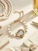 Pulsera de perlas superventas transfronteriza, reloj de cuarzo con números romanos para mujer, disponible en stock, tres colores para elegir