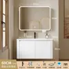 Tocador de baño engrosado y ahorrador de espacio con diseño en color crema, que cuenta con un lavabo redondeado, lavabo cerámico integrado y un lavabo de una sola pieza.