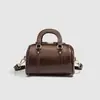 Bolsa Travesseiro Retrô para Mulheres 2026 Nova Bolsa Cilíndrica de Nicho Versátil Bolsa Travesseiro Texturizada Fashion Bolsa de Mão Transversal