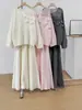 Conjunto de punto suave estilo francés 2026 otoño e invierno nuevo conjunto de dos piezas de suéter con flores tridimensionales + falda larga para mujer