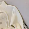 Casaco suéter com gola alta e fivela de borla retrô estilo chinês feminino outono e inverno manto de batalha de Ano Novo cardigã de tricô vermelho de Ano Novo