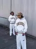 Venta al por mayor transfronteriza europea y americana: estampado de leopardo, bordado de letras, pantalones largos de estilo urbano casual, sudaderas con capucha y pantalones de chándal unisex
