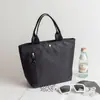 Bolsa de mão novo estilo grande capacidade versátil à prova de respingos bolsa simples de pano versão coreana cor sólida à prova d'água bolsa tote casual resistente à sujeira