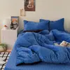 Nueva colección de invierno: Rayado azul y negro, cálido y engrosado, juego de ropa de cama de cuatro piezas con acabado de terciopelo de leche, que incluye una sábana plana, una funda de edredón y una sábana bajera.