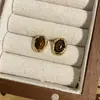 Pendientes de Aguja de Plata S925 Color Caramelo Maillard Retro Otoño e Invierno para Mujer Pendientes de Botón Geométricos Avanzados con Piedra de Ojo de Tigre Venta al por Mayor