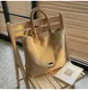 Bolsa de lona bordada de baja saturación, simple y elegante para trabajadoras de oficina, adecuada para el uso diario como bandolera o bolsa de mano.