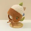 Bonitos y adorables gorros de otoño e invierno para niños, con diseño de poner, material de punto y una serie de dibujos animados, que brindan abrigo y protección para los oídos para bebés y niños pequeños.