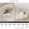 Bolso de mano casual simple estilo coreano para mujer 2026 nueva moda para ir al trabajo color liso almohada bandolera