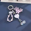Nuevo amuleto de bolsa triple flor de acrílico, versátil colgante para llaves con cuenta ojo de gato en forma de corazón impresa, regalo pequeño