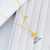 Mismo estilo tienda de oro arena oro joyería juego flor de cerezo cadena cadena integrada mujer retro lujo ligero moda diseño de alta gama sentido cadena para suéter