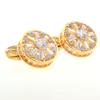 Los fabricantes de Dongguan suministran gemelos huecos de cristal de lujo redondos, gemelos de oro K con circonita estrella Ruili para uñas.