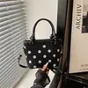 Moda fuente de fábrica transfronteriza 2026 nuevo diseño de lunares en nailon bolso de mano casual para el día a día bolso de hombro tipo cubo