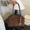 Bolso de mano de color liso para ir al trabajo, nuevo de principios de otoño 2026, bolso tipo cubo casual a la moda, bolso de hombro cruzado simple y elegante