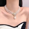 Collar de perlas con cadena de clavícula y cruz ovalada de ojo de gato con incrustaciones de diamantes, collar retro de estilo francés con perla larga distintiva para mujer