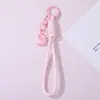Chaveiro de pulseira para celular com pingente de bolo rosa, pulseira de pulso trançada feminina, acessório universal anti-queda para bolsas e chaves