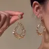 Pendientes Huecos de Gota de Agua con Tachuelas de Diamante en Plata para Mujer 2026 Nuevo Estilo Pendientes de Lujo Ligero de Gama Alta Accesorios para Orejas de Diseño Único de Nicho