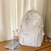 Mochila de estilo japonês, moderna e esteticamente agradável, com designs de estrelas e luas, perfeita para alunos do ensino fundamental II e médio, oferecendo uma opção casual e leve.