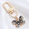 Llavero de Mariposa de Esmalte Blanco y Negro de Gama Alta, Colgante Completo de Diamante, Mariposa Combinada con Colgante de Oro, Llavero DIY, Colgante Pequeño