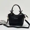 Nuevo bolso tipo cubo de cuero, con una textura suave de cuero PU, versátil bolso cruzado o de hombro, con un asa de cuerda de algodón anudada, un bolso de mano único y elegante para mujer
