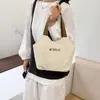 Bolsa de ombro em lona para mulheres 2026 novo modelo simples versátil bolsa tote grande capacidade bolsa de mão para o dia a dia bolsa casual debaixo do braço