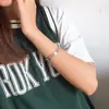 [56] comercio exterior acero de titanio joyería al por mayor moda artículo de fiesta diamante blanco liso tres colores en el brazalete