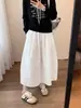 Falda midi negra de capullo para mujer primavera y otoño nueva cintura elástica que cubre las caderas adelgazante cintura alta largo medio gran vuelo falda larga