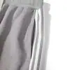 Pantalones deportivos casuales holgados de tres rayas, nuevo estilo para primavera y otoño, pantalones largos de color liso simples, joggers ajustados para hombre al por mayor