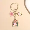 Llavero de hongo estilo cuento de hadas transfronterizo Temu, lindo colgante de aleación de casita con flor y aceite, decoración para bolso
