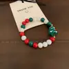 Transfronterizo europeo y americano nuevo estilo navideño dulce lindo combinable esmalte de imitación muñeco de nieve hombrecillo de azúcar pulsera de cuentas roja verde