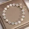 2025 Novo Bracelete Olho de Gato Bracelete de Cristal Trevo de Quatro Folhas Corda Elástica Pérola Shijia Bracelete de Contas de Transferência Atacado