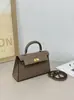 Elegante bolsa Kelly com fivela de prata e padrão manual 2026 nova moda feminina bolsa de mão de segunda geração com fivela dourada, bolsa de ombro e transversal